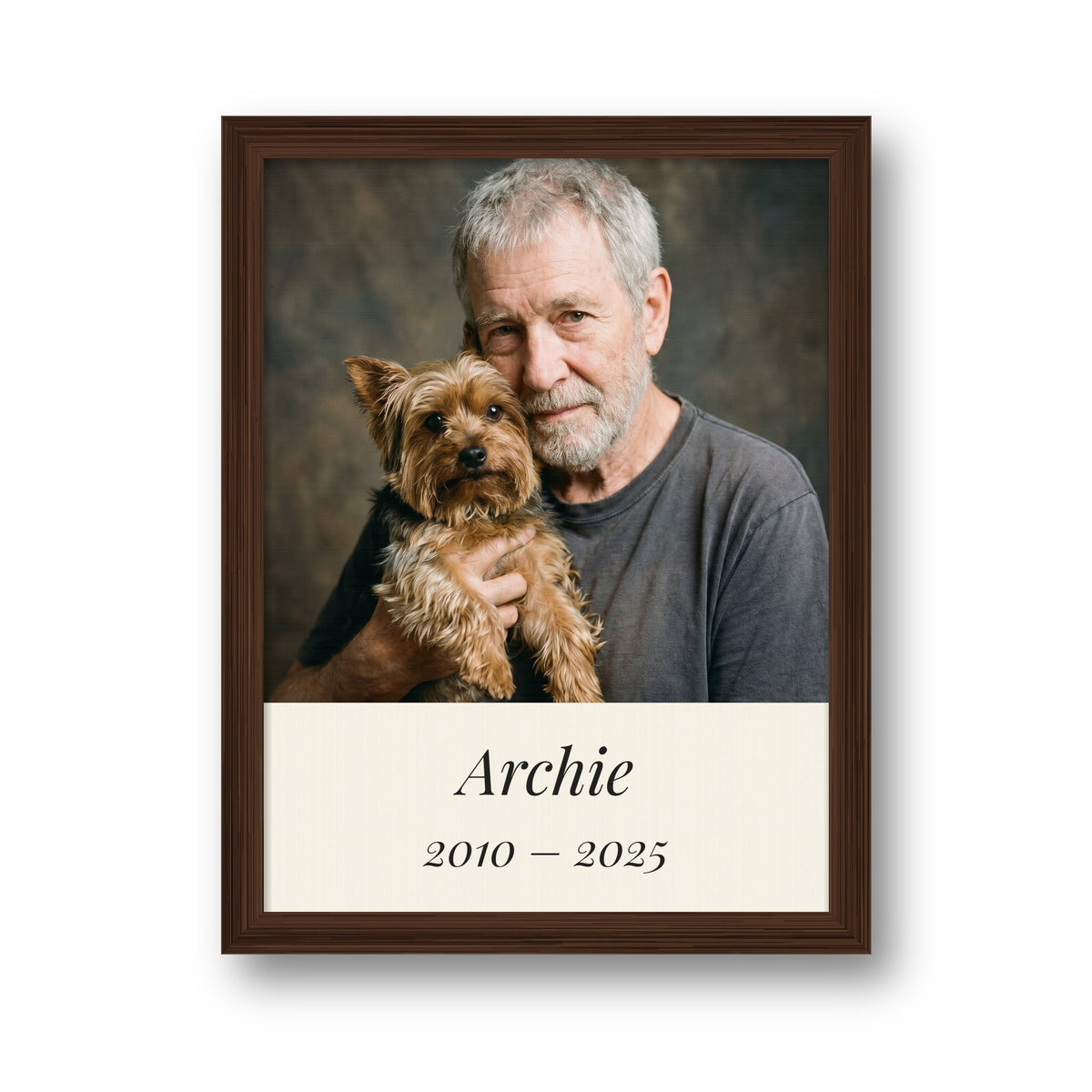 Personalised pet memorial framed canvas in a dark wood frame, with a man holding his Yorkie, the name Archie and the years 2010 to 2025