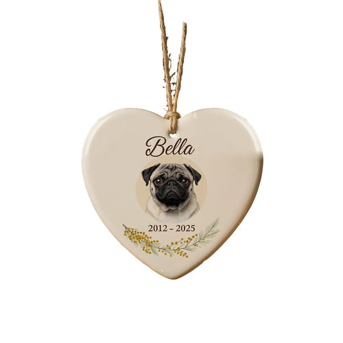 Personalised pet memorial Christmas ornament: white ceramic heart with a pug photo, the name Bella and 2012 – 2025